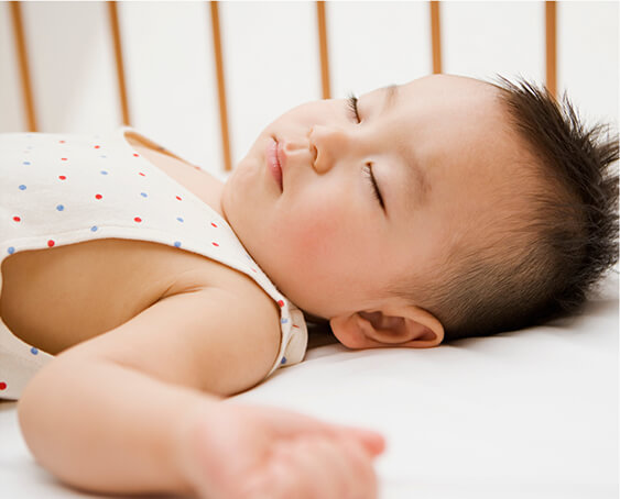 A baby sleeping in a crib